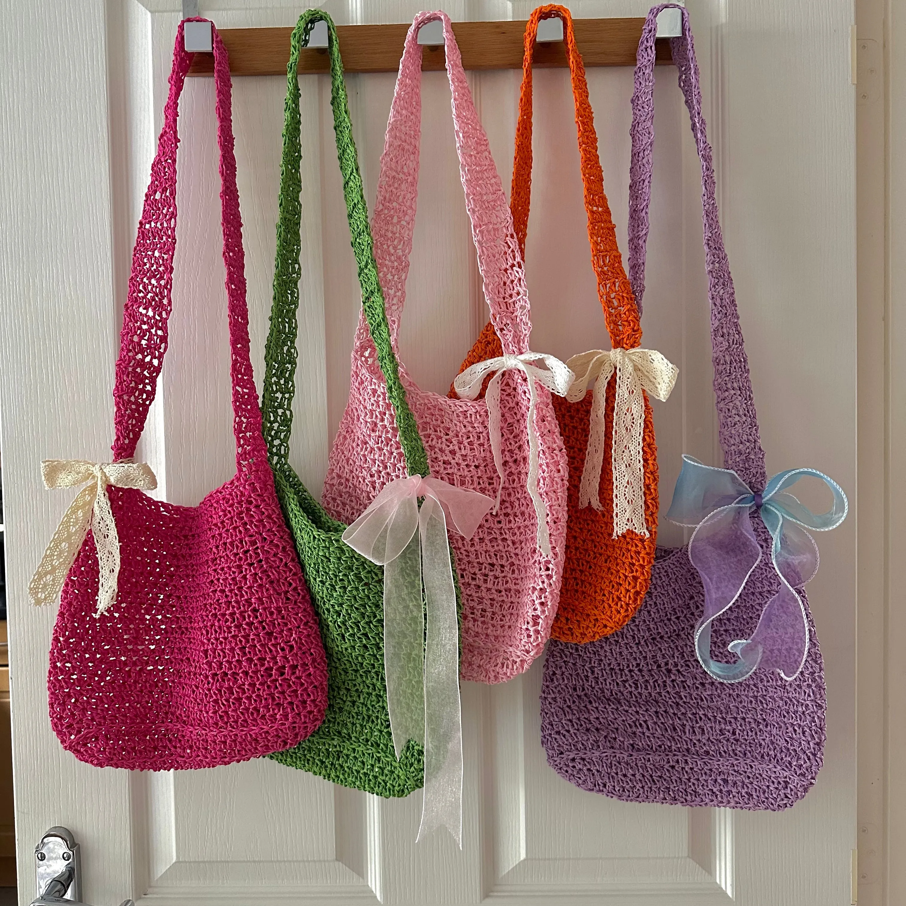 Handmade baby pink crochet straw bag with white lace bow